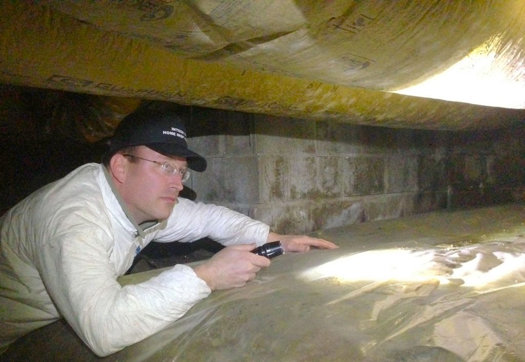 Cameron inspects a crawlspace